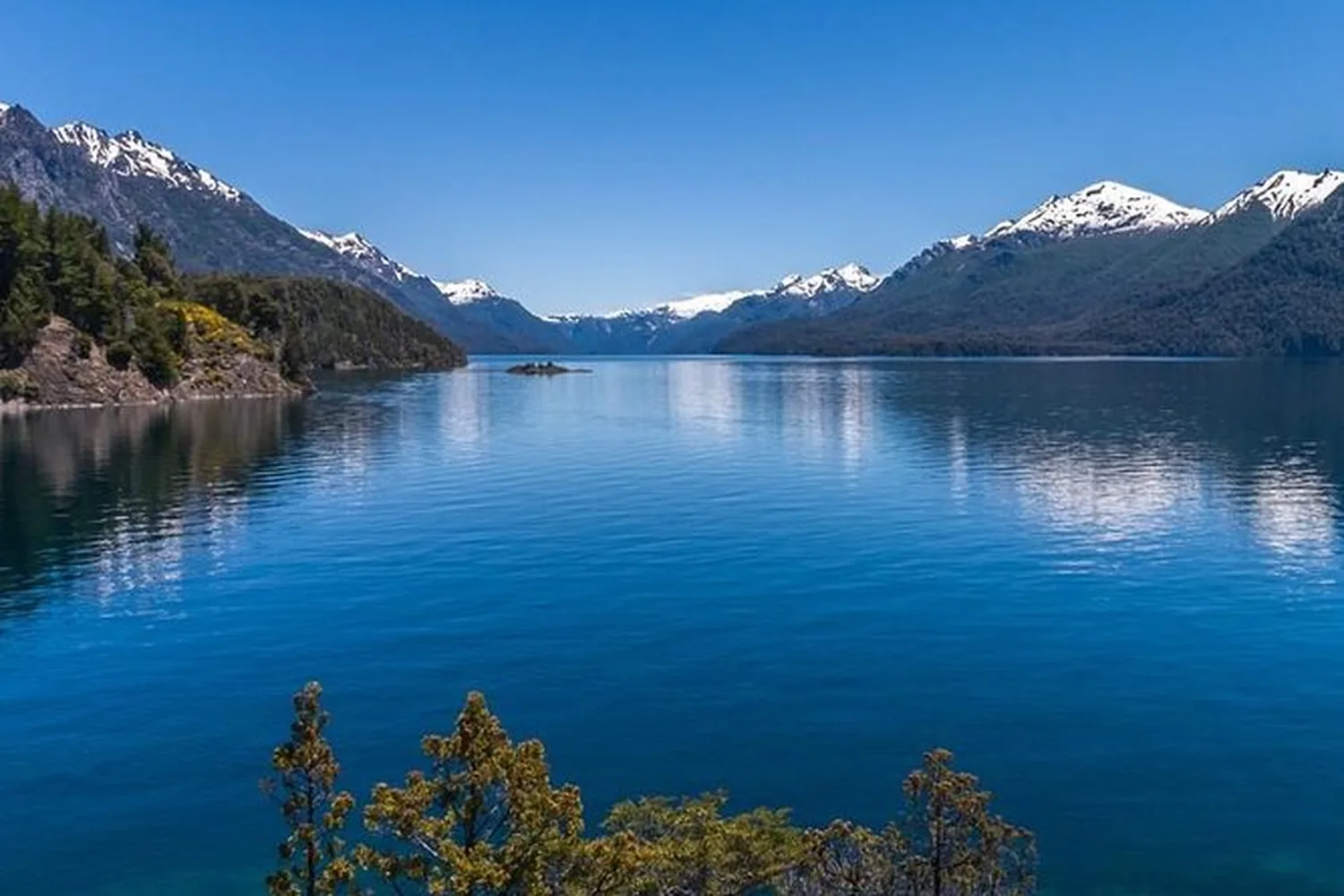 Vista del Lago Nahuel Huapi desde el Circuito Chico, con los cerros nevados de fondo.